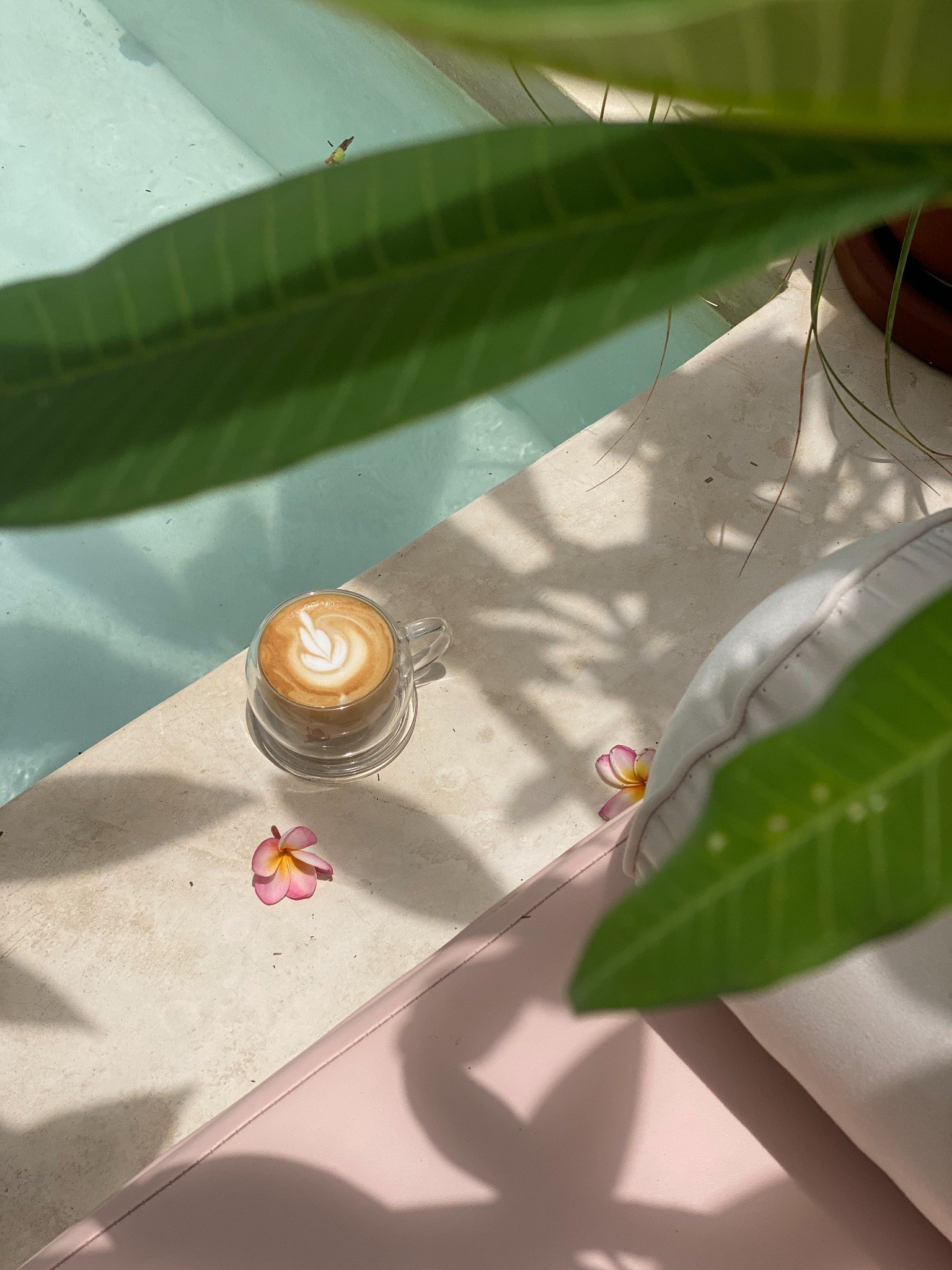 Coffee by the pool — legs and latte art